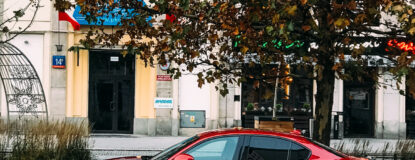 red-sedan-parked-on-the-side-of-the-road