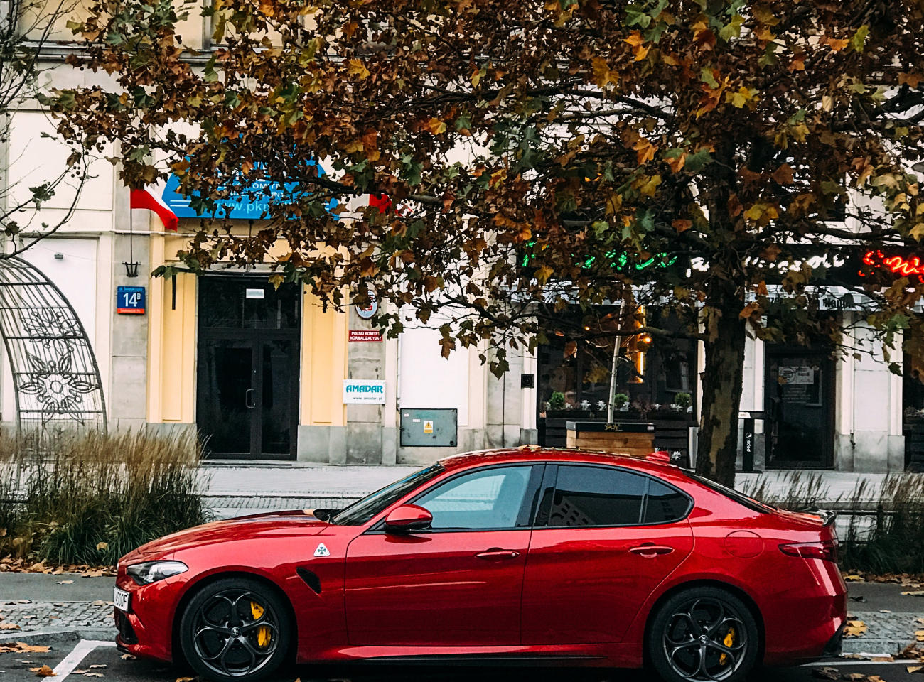 1707716896128 red-sedan-parked-on-the-side-of-the-road